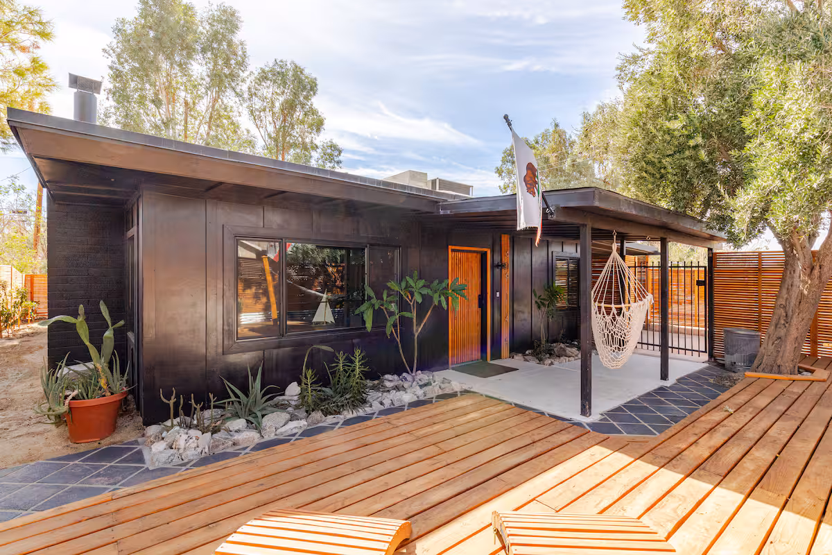 Dark exterior with orange wood front door