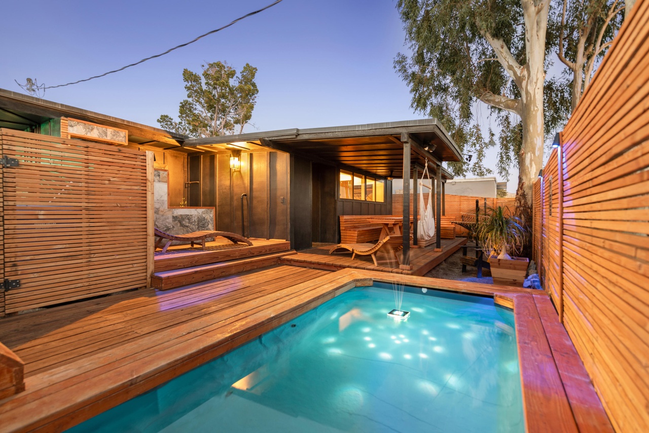 Private pool with wood deck at twilight
