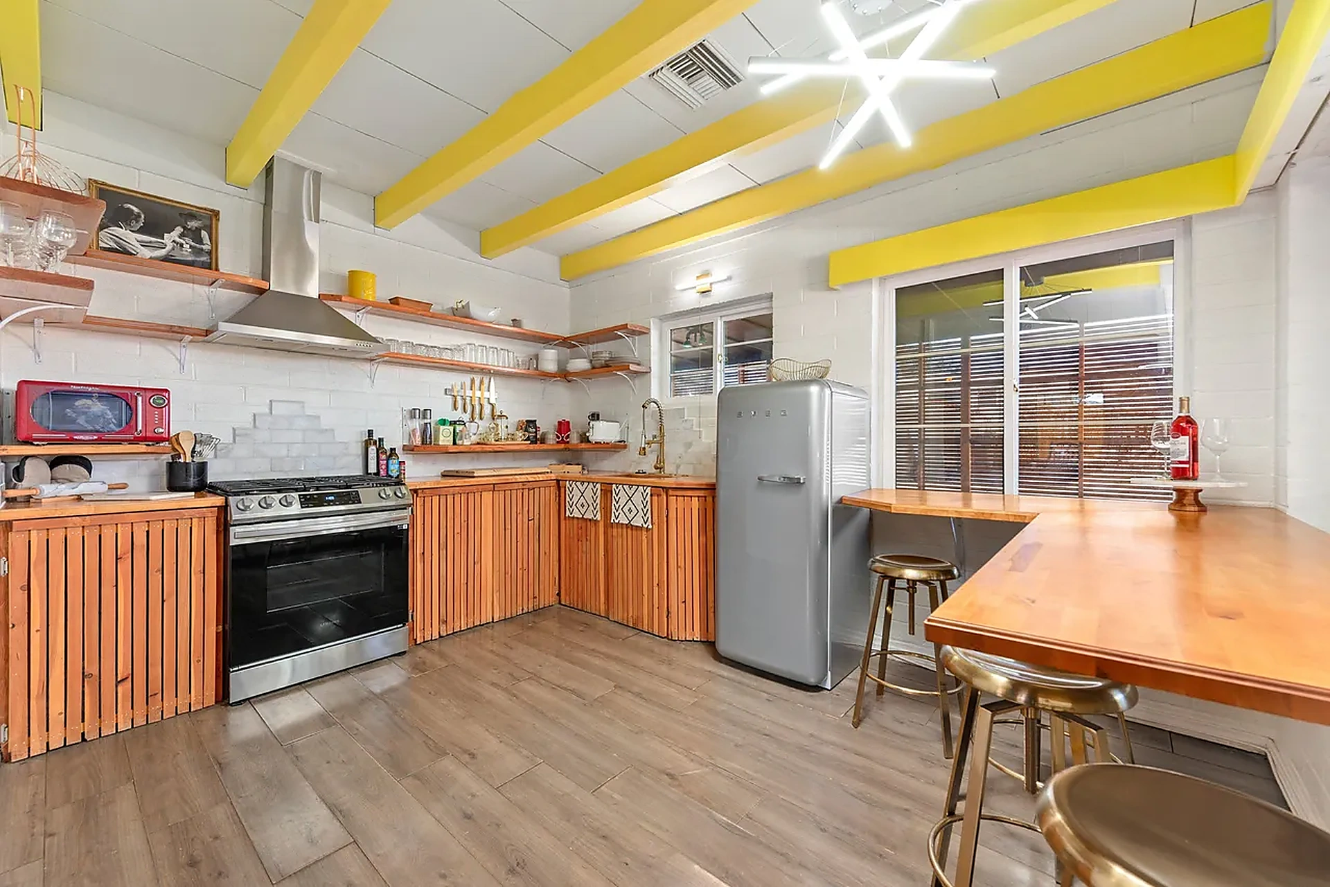 Kitchen with yellow beams and SMEG fridge