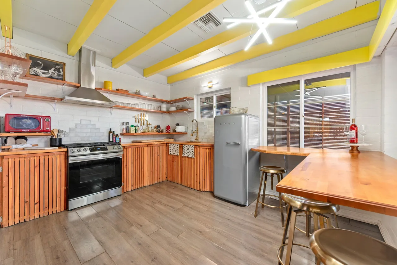 Kitchen with yellow beams and SMEG fridge