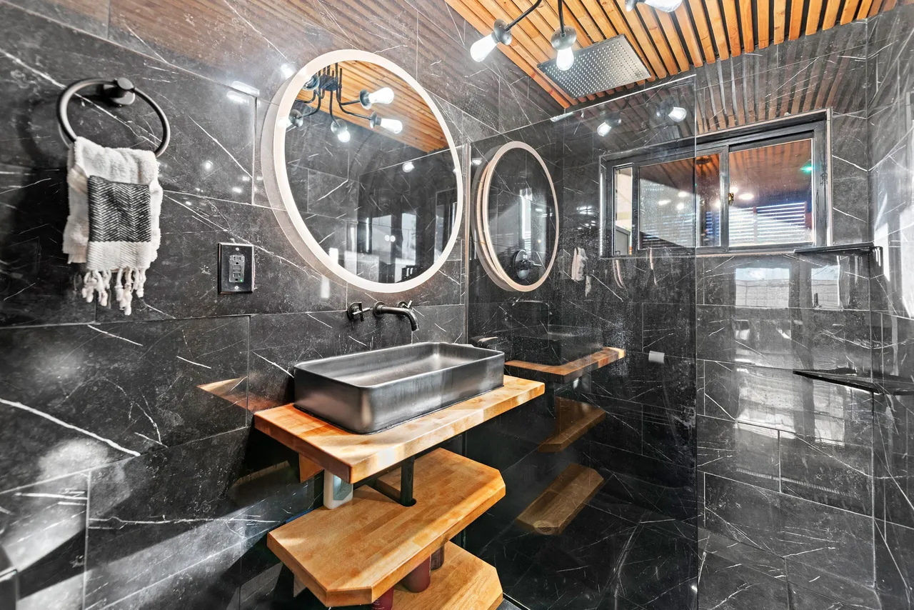Black marble bathroom with LED mirror