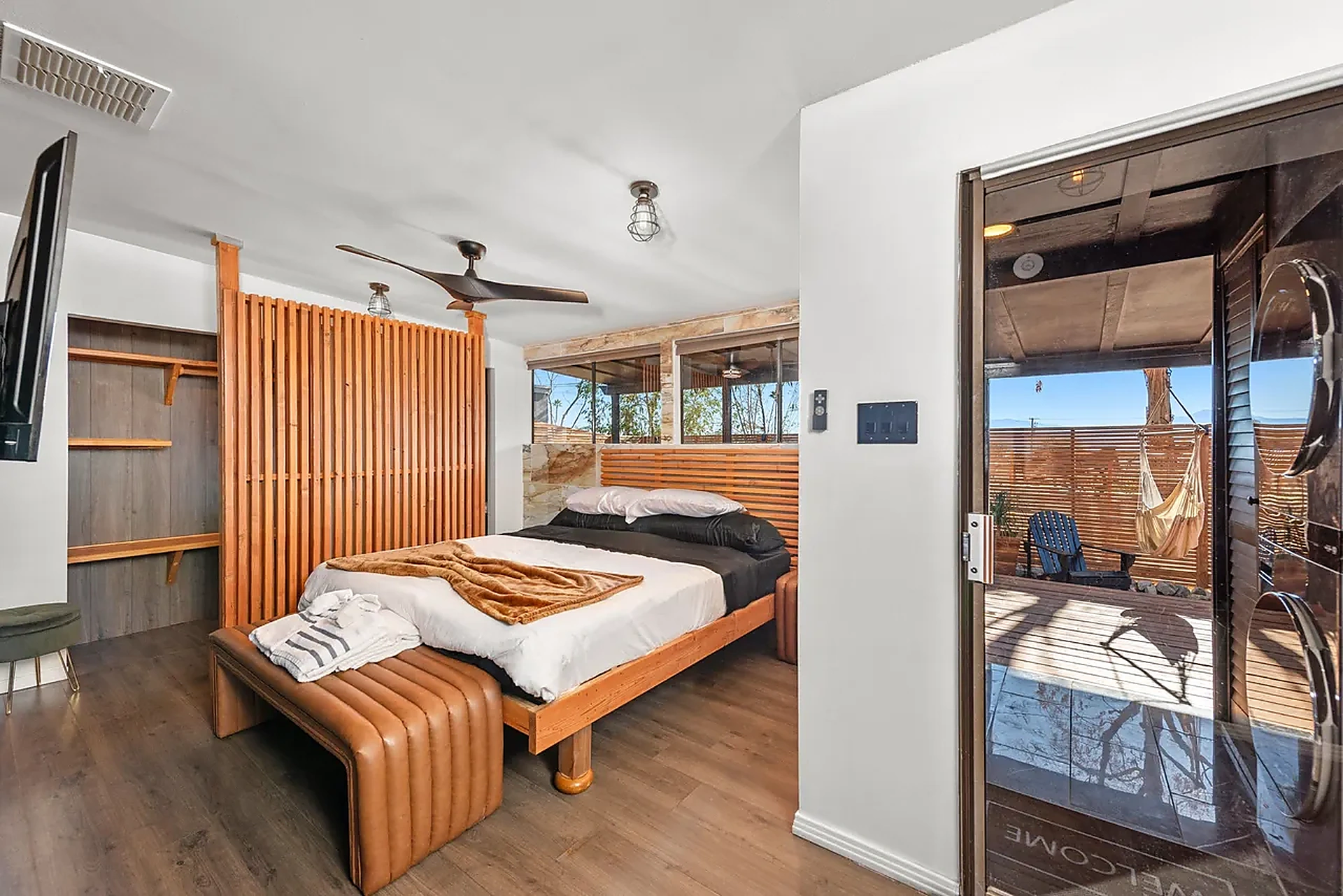 Bedroom with wood divider and courtyard access