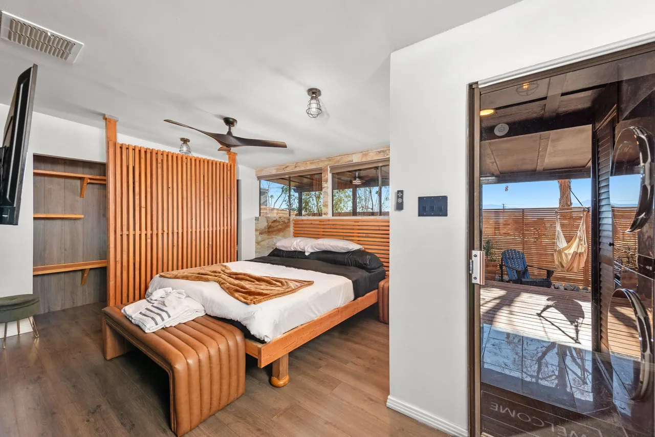 Bedroom with wood divider and courtyard access