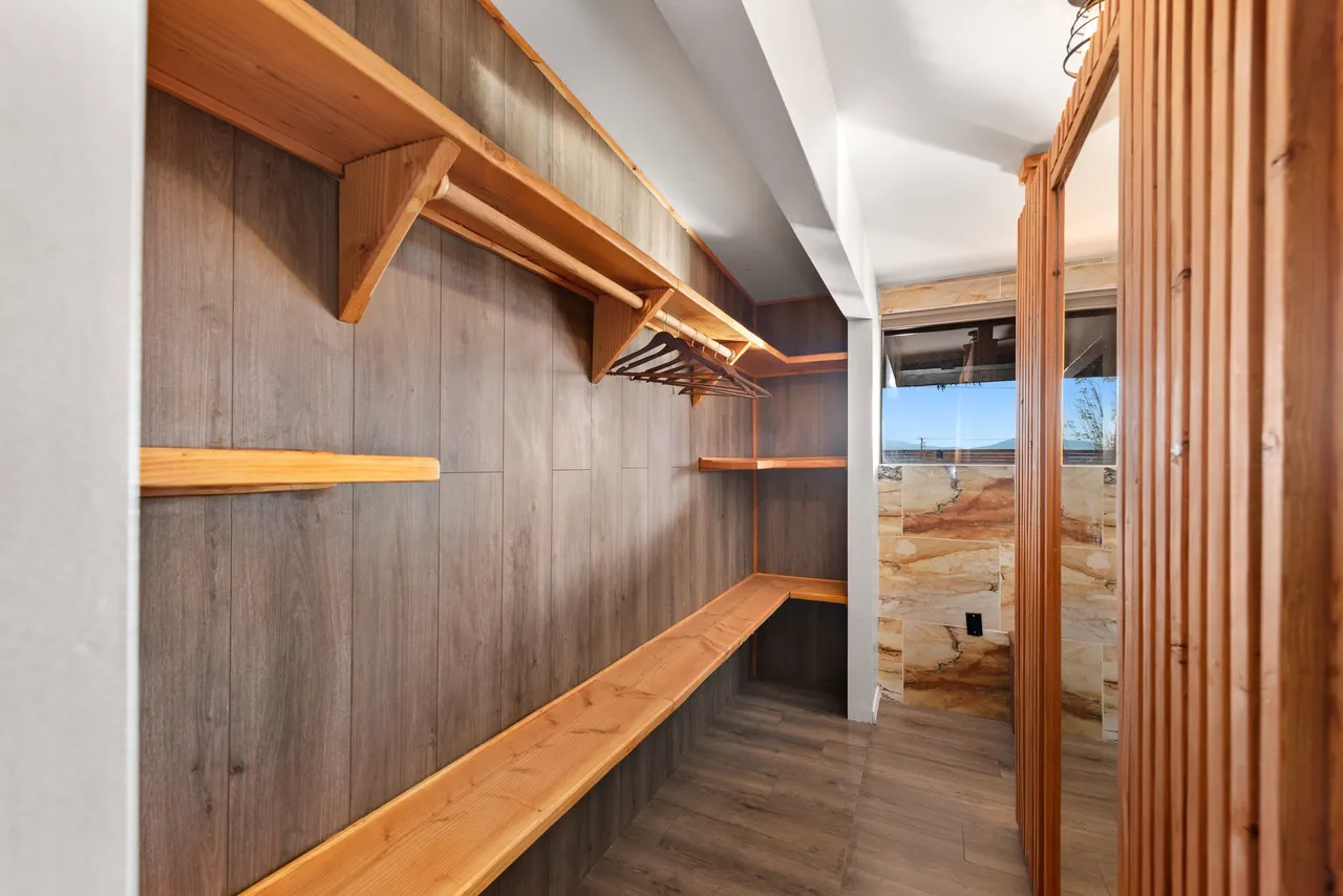 Custom walk-in closet with wood shelving