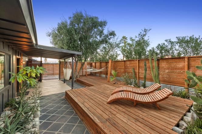 Wood deck lounge with hammock and desert landscaping